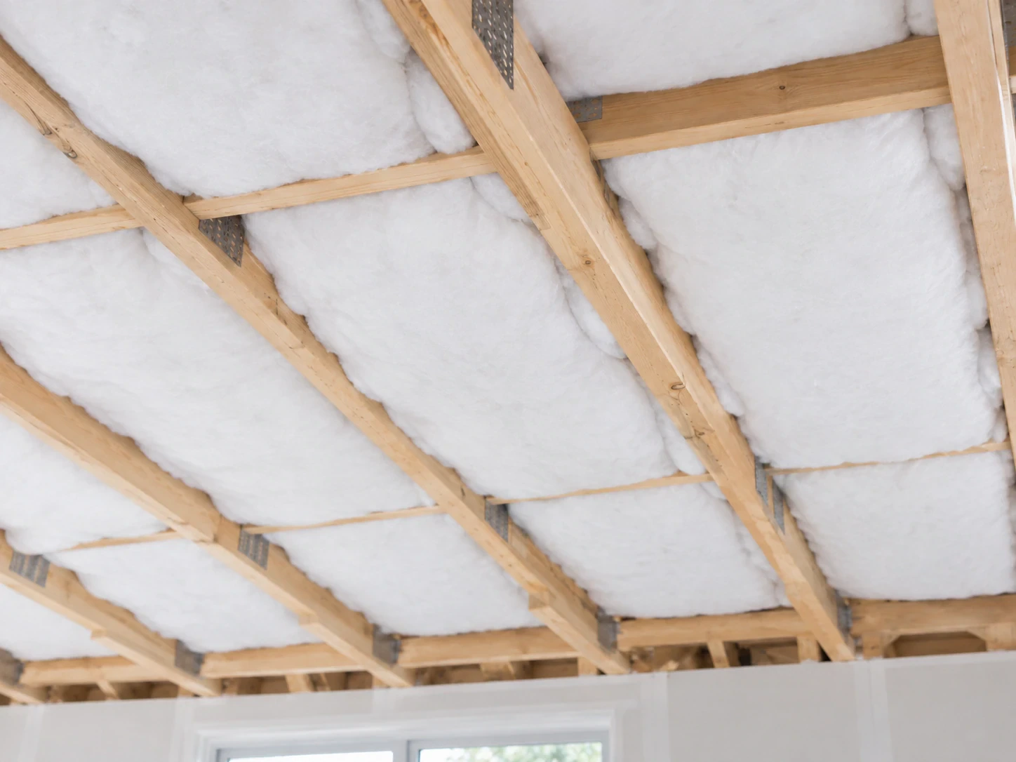 Ceiling insulation installed between timber roof framing